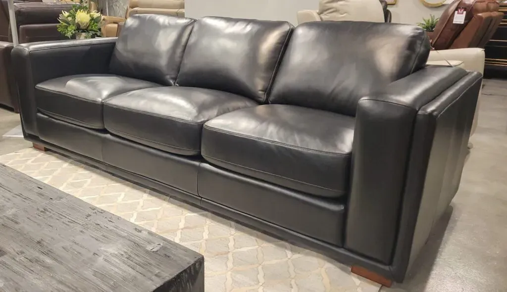 Black Italian leather sofa in a showroom